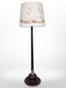 A mahogany standard lamp with floral shade,