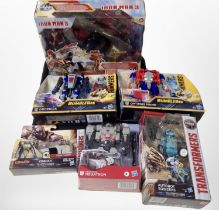 Six Hasbro Transformers and Iron Man 3 figures, boxed.