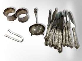 A silver strainer, pair of sugar tongs,