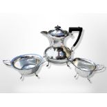 A silver-plated three-piece tea service, teapot 22 cm high.