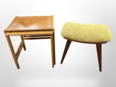 A nest of two teak tables and a further teak framed footstool on tapering legs
