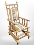 A Danish blond oak rocking chair in studded tapestry fabric,