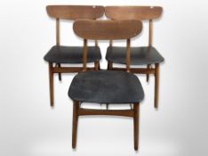 A pair of 20th century Danish black vinyl upholstered dining chairs plus another similar