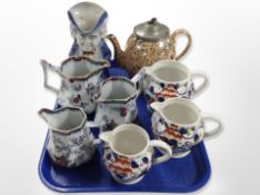 Three Mason's ironstone graduated jugs together with a Toby jug,