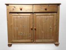 A contemporary pine double door side cabinet,