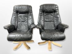 A pair of black stitched leather swivel armchairs