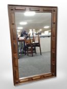 A stained beech framed overmantel mirror,