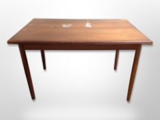 A 20th century Danish teak pull out extending dining table,
