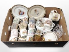 A collection of antique commemorative mugs and plates