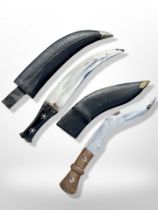 A kukri knife in sheath, plus a further knife with curved blade, longest 45cm.