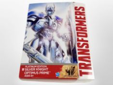 A Hasbro Transformers Platinum Edition Silver Knight Optimus Prime figure, boxed.