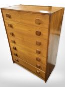 A Danish teak and MDF seven drawer chest,