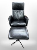 A Hjort Knudsen stitched black leather swivel armchair with matching footstool
