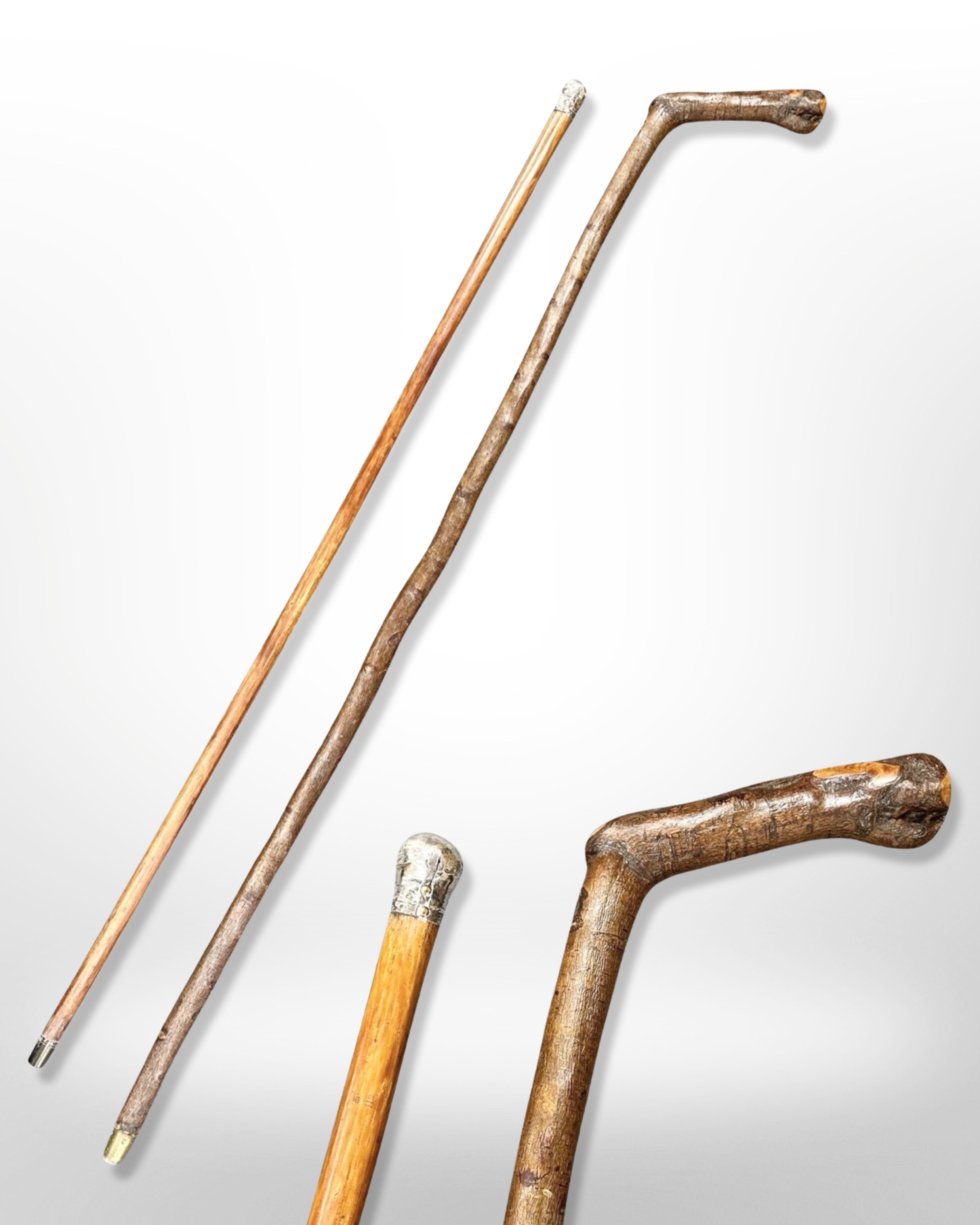 An antique silver-mounted walking cane, length 90cm, and a further hazelwood walking stick.