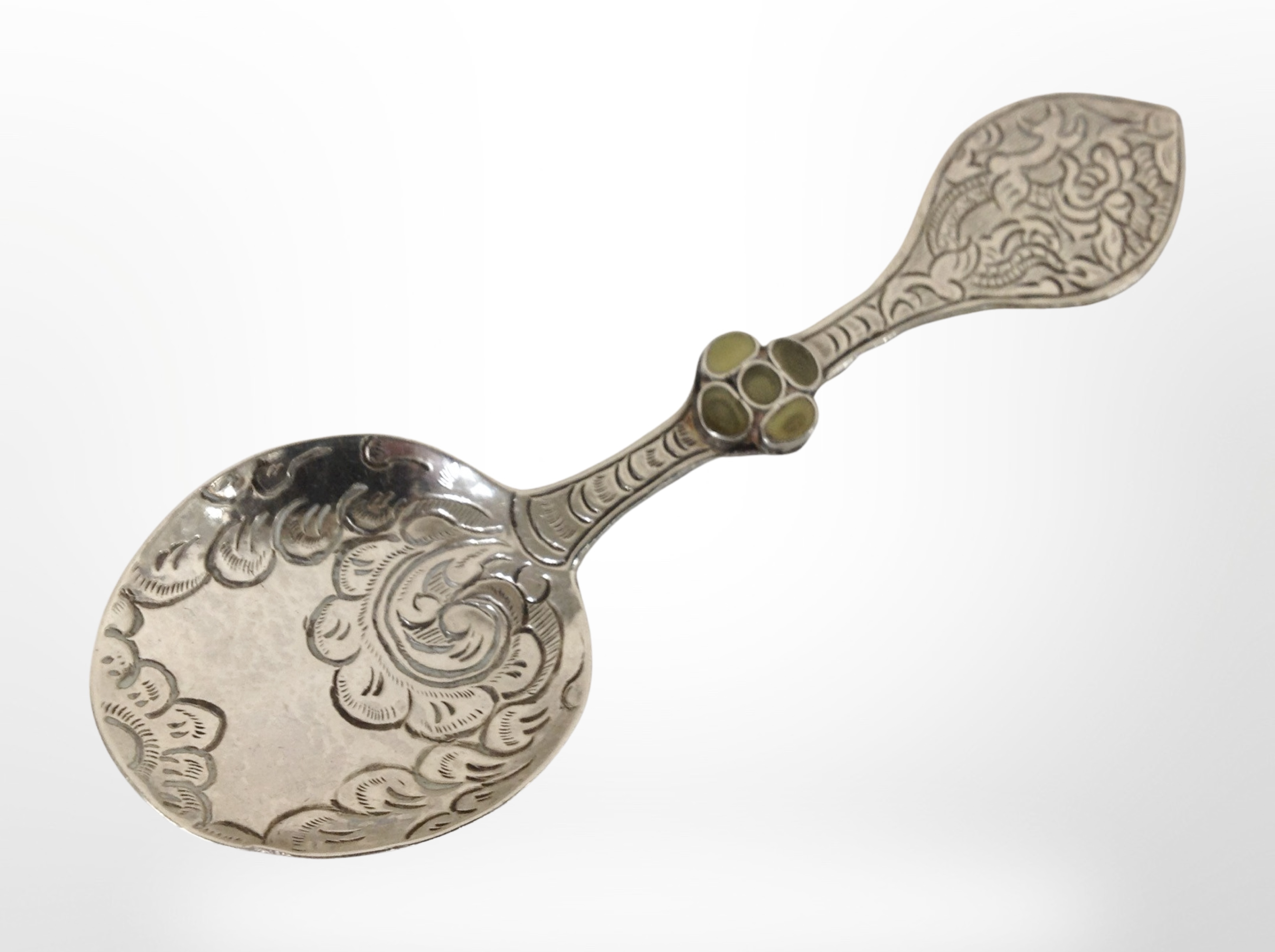 An oriental silver caddy spoon inset with green hardstones, length 11cm.