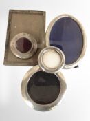 Five various silver-mounted photo frames.