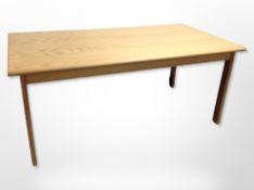 A late 20th century pine dining table,