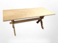 A blond oak refectory coffee table,