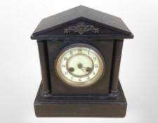 A Victorian black slate mantel clock with enamelled dial, height 28cm.