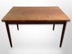 A Danish teak pull-out extending dining table,