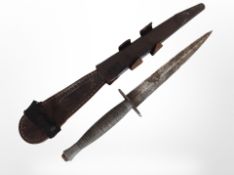 A Second World War Fairbairn-Sykes third-pattern fighting knife in leather sheath.