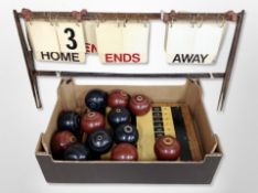 A box of lawn bowls and score markers
