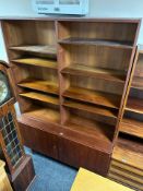 A Danish teak open bookcase fitted cabinets beneath,