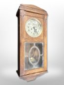 An early 20th century Continental oak eight day wall clock with silvered dial,