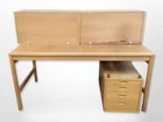 A 20th century Scandinavian oak desk with four drawer pedestal beneath, desk 156 cm wide,