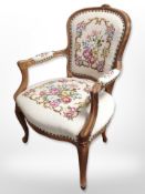 A continental carved beech salon armchair in tapestry fabric