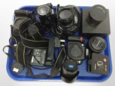 Digital cameras and lenses including Nikon D40, Nikon Coolpix 5700, Nikon D3200, Sony MVC-CD500,