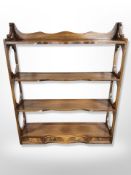 A reproduction mahogany four tier wall shelf,