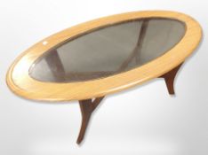 A 1970's teak effect oval coffee table,