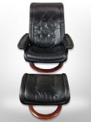 A Norwegian Ekornes black stitched leather swivel armchair with matching footstool