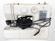 A Janome electric sewing machine with lead and pedal