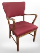 A continental walnut open armchair in red upholstery