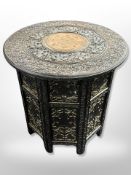 An Anglo-Indian carved hardwood and brass-inlaid occasional table with later plate glass top,