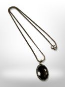 A 9ct yellow gold chain, length 48 cm with continental yellow gold smokey quartz pendant.