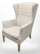 A 20th century wingback armchair in checkered fabric
