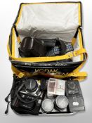 A Kodak camera bag containing assorted cameras and lenses, Olympus OM-1 camera,