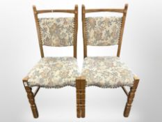 Six Danish oak dining chairs in studded floral upholstery