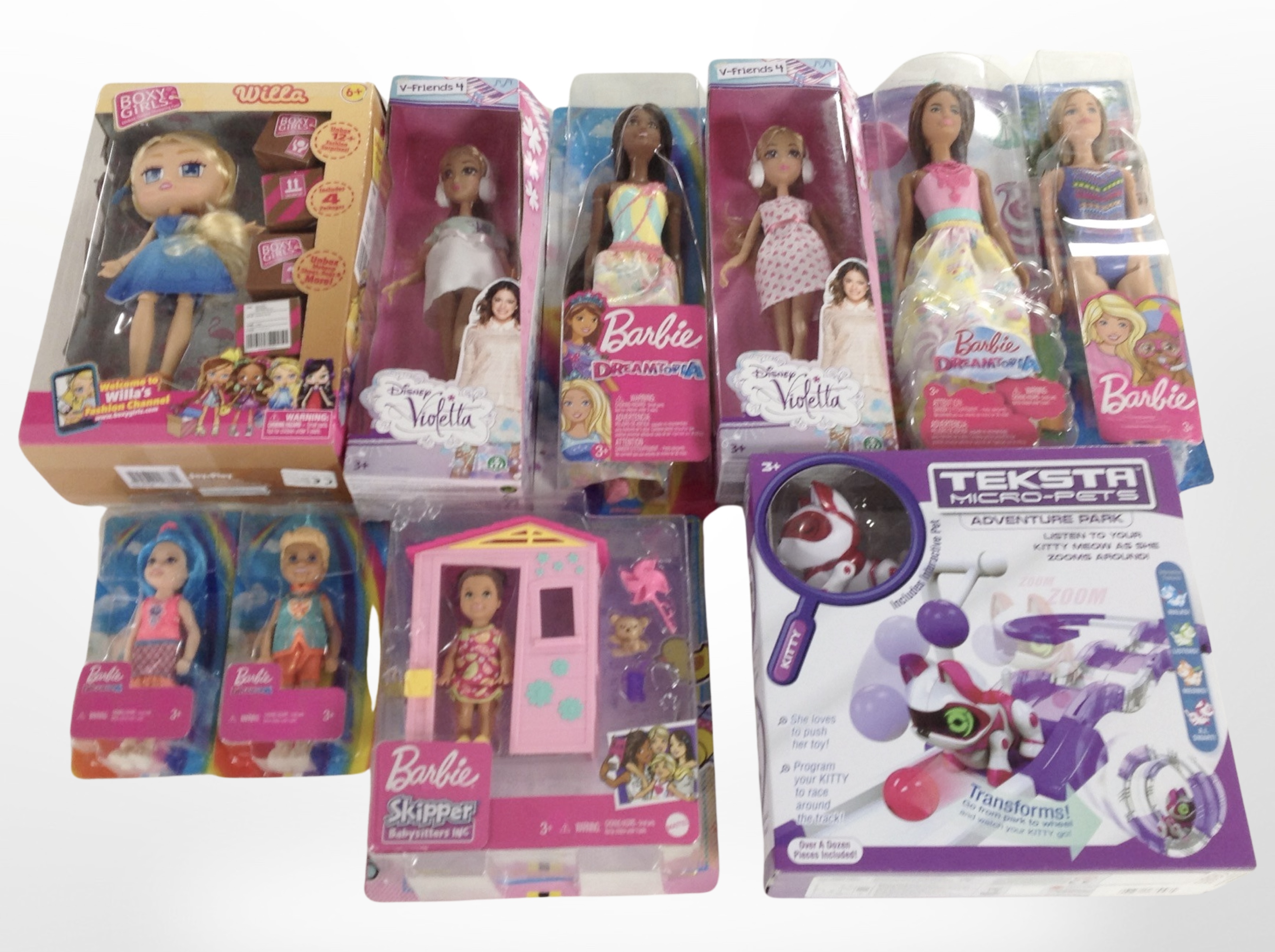 A box of Mattel Barbie dolls and a Teksta Micro Pets figure,