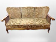 An early 20th century continental carved beech and bergere three piece lounge suite