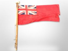 A naval flag on pine flag pole,