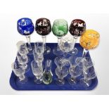 A group of drinking glasses including five coloured hock glasses,