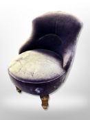 An early 20th century salon chair in distressed upholstery,