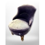 An early 20th century salon chair in distressed upholstery,