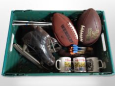 A box of pair of vintage leather ice skates, American footballs,