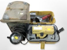 A Topcon surveyor's level in case together with a vintage military spot lamp with canvas cover and