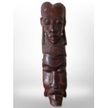 An African hardwood carving of two faces,